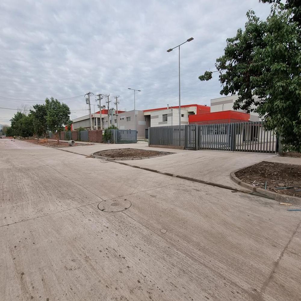 Después: calle pavimentada en hormigón con accesos terminados